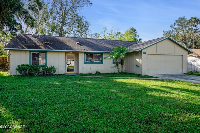 500 Sandy Oaks Blvd, Ormond Beach, FL 32174 - single story home featuring a front yard, asphalt driveway, a garage, and board and batten siding