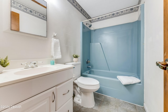 full bathroom featuring toilet, washtub / shower combination, vanity, and a textured ceiling