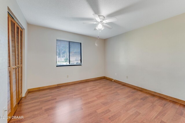 500 Sandy Oaks Blvd, Ormond Beach, FL 32174 - unfurnished bedroom featuring light wood-style floors, a closet, baseboards, and a ceiling fan