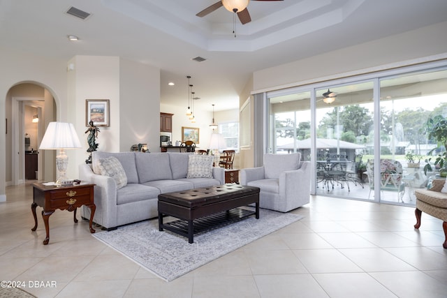 tiled living room with ceiling fan