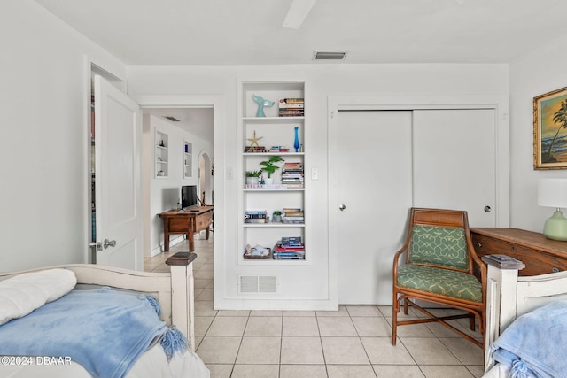 tiled bedroom with a closet