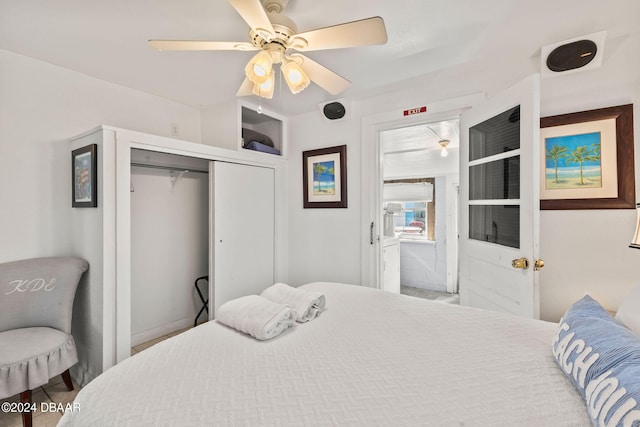 bedroom with ceiling fan and a closet