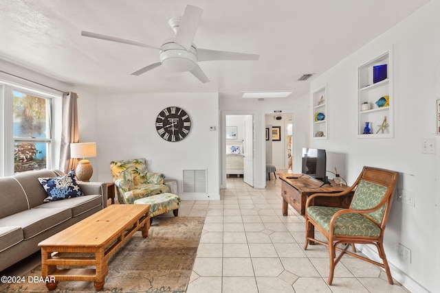 tiled living room with built in shelves and ceiling fan