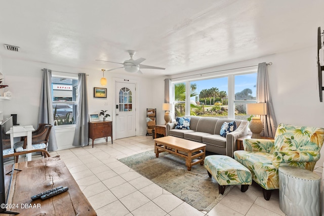 living room with light tile patterned flooring and ceiling fan