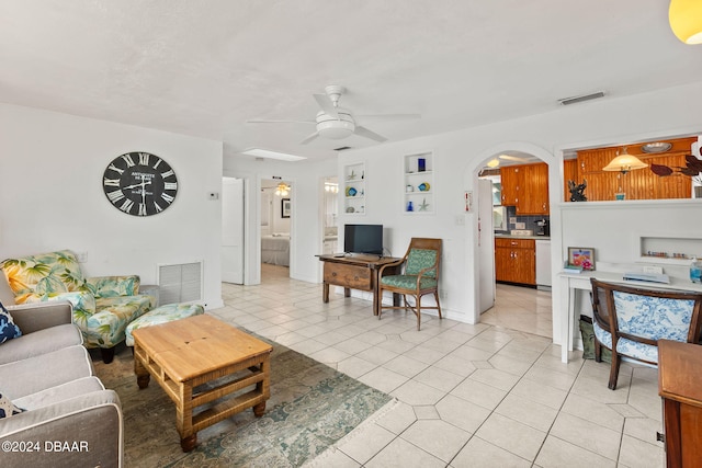 tiled living room with ceiling fan