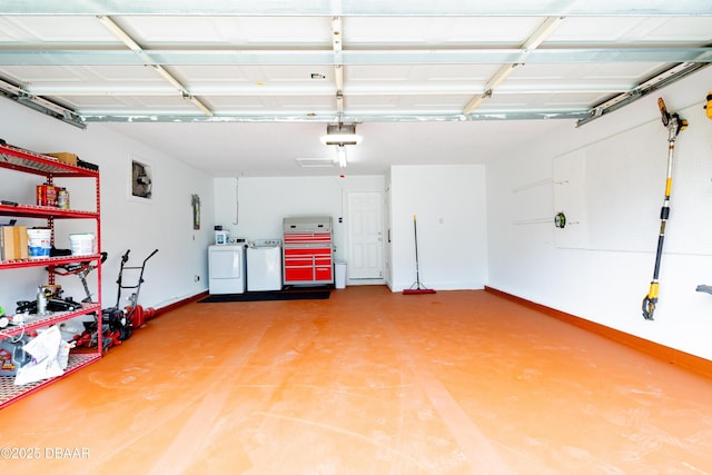 garage with washing machine and dryer and a garage door opener