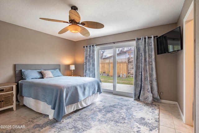 bedroom featuring access to outside, a textured ceiling, ceiling fan, and light tile patterned floors