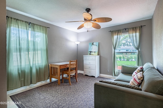 office space with ceiling fan and a textured ceiling