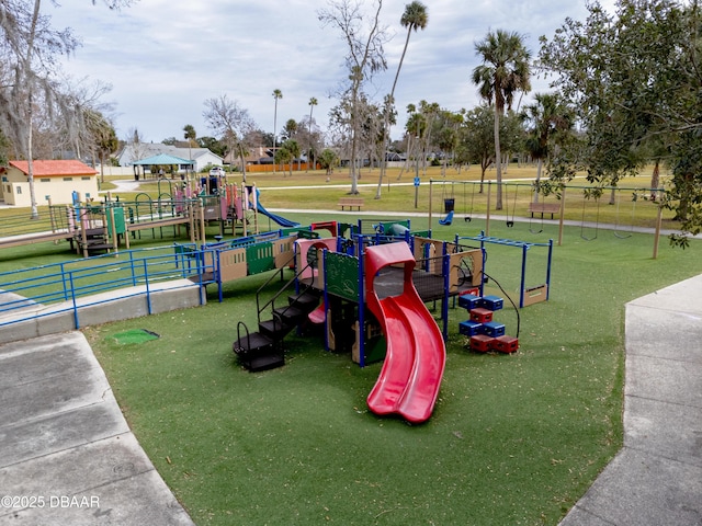 view of home's community with a playground and a lawn