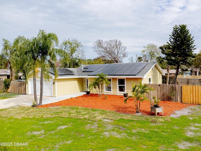 single story home featuring a garage, solar panels, and a front lawn