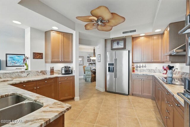 20 Porto Mar Unit 302, Palm Coast, FL 32137 - kitchen featuring stainless steel fridge, recessed lighting, light stone counters, and light tile patterned flooring