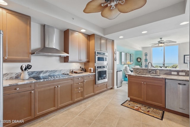 20 Porto Mar Unit 302, Palm Coast, FL 32137 - kitchen featuring appliances with stainless steel finishes, wall chimney range hood, a ceiling fan, recessed lighting, and light stone counters