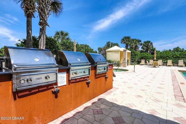 20 Porto Mar Unit 302, Palm Coast, FL 32137 - view of patio featuring an outdoor kitchen
