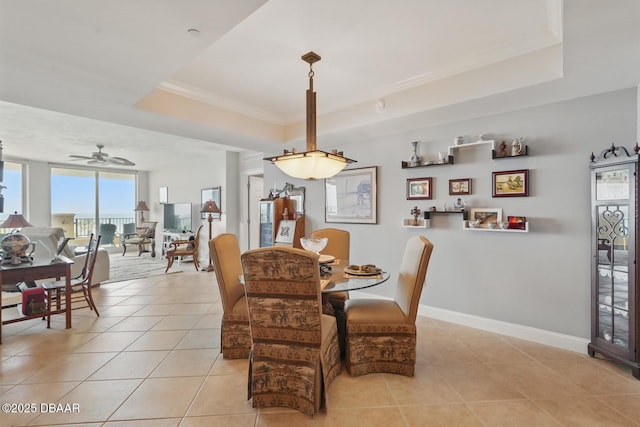 20 Porto Mar Unit 302, Palm Coast, FL 32137 - dining space featuring a raised ceiling, light tile patterned floors, a ceiling fan, and crown molding