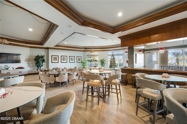 20 Porto Mar Unit 302, Palm Coast, FL 32137 - dining room featuring ornamental molding, a tray ceiling, recessed lighting, healthy amount of natural light, and light wood finished floors