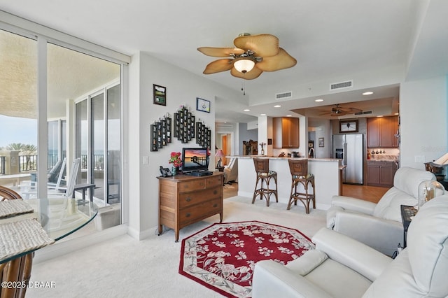 20 Porto Mar Unit 302, Palm Coast, FL 32137 - living room featuring a ceiling fan, floor to ceiling windows, and light carpet
