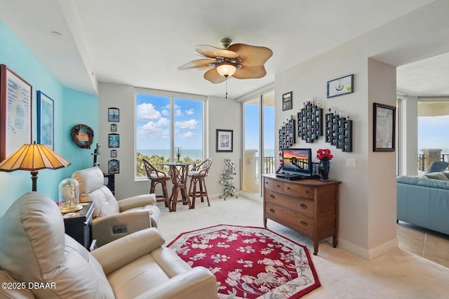 20 Porto Mar Unit 302, Palm Coast, FL 32137 - living area with light carpet, healthy amount of natural light, and a ceiling fan