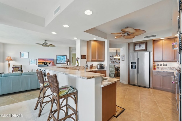 20 Porto Mar Unit 302, Palm Coast, FL 32137 - kitchen featuring stainless steel fridge with ice dispenser, a ceiling fan, a peninsula, a breakfast bar area, and recessed lighting