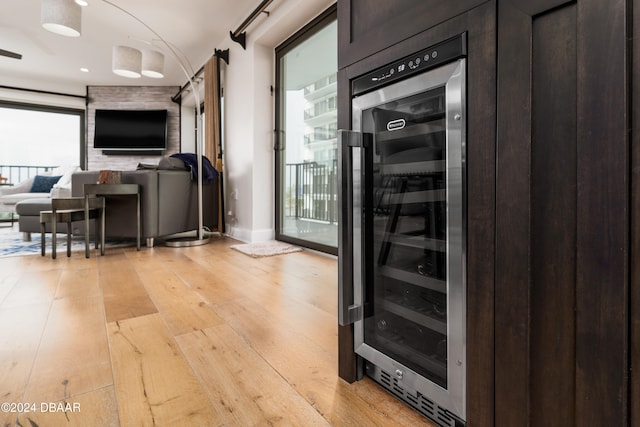 interior space with a barn door, light hardwood / wood-style floors, and wine cooler