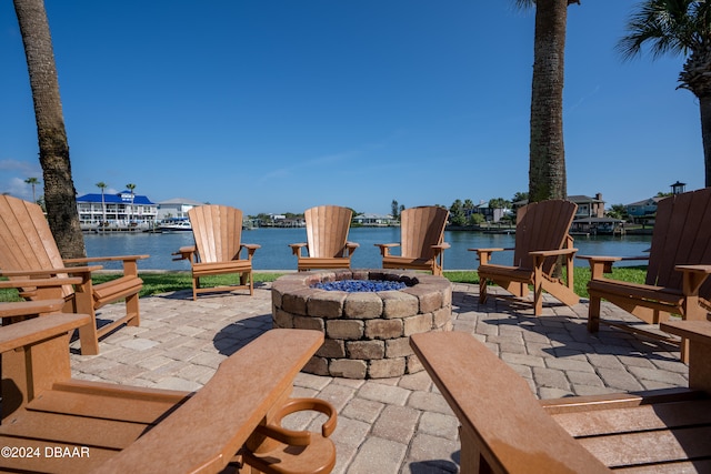 view of patio / terrace with a water view and an outdoor fire pit