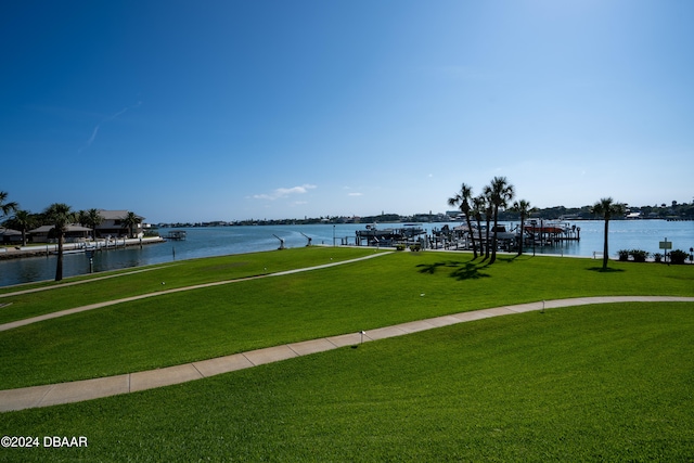 view of home's community with a yard and a water view