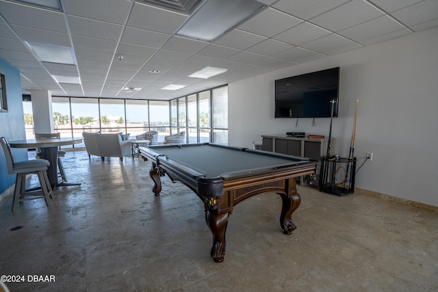 recreation room featuring a paneled ceiling, a healthy amount of sunlight, floor to ceiling windows, and pool table