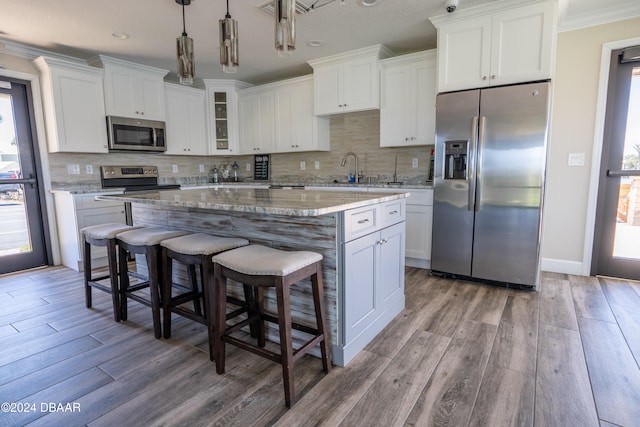 kitchen featuring a center island, white cabinets, and appliances with stainless steel finishes