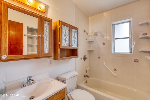 full bathroom with tiled shower / bath, vanity, and toilet