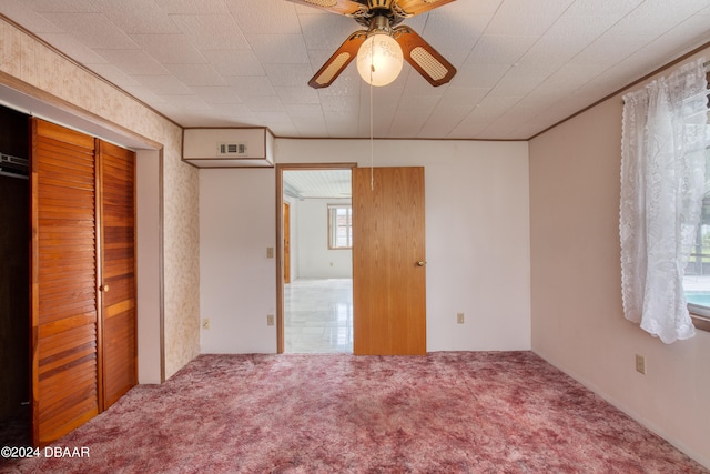 unfurnished bedroom featuring carpet, a closet, and ceiling fan