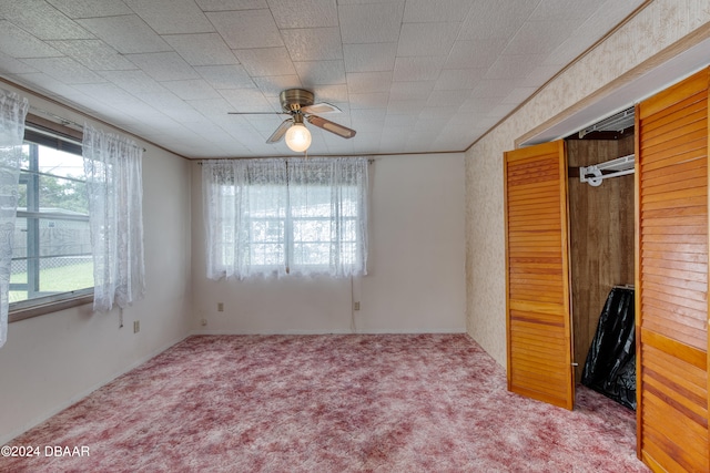 unfurnished bedroom featuring carpet flooring, a closet, and ceiling fan