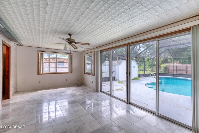 interior space with ceiling fan