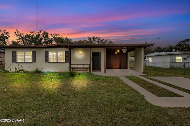 ranch-style house featuring a yard and a carport