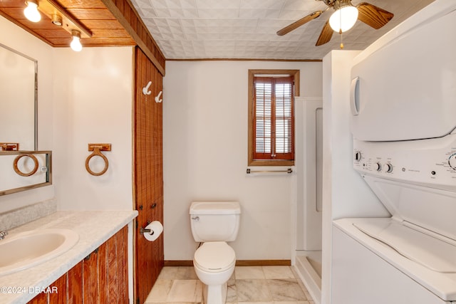 bathroom featuring vanity, ceiling fan, toilet, walk in shower, and stacked washer / dryer