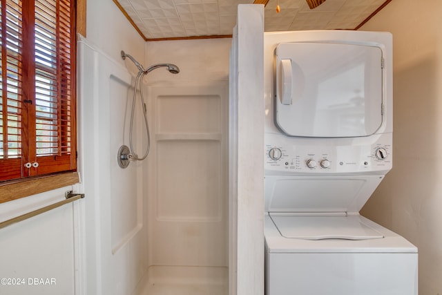 laundry room with stacked washer / dryer