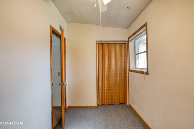 hallway with carpet floors