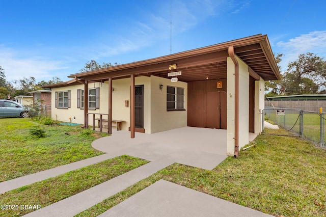 back of property featuring a lawn