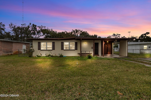 ranch-style home with a yard