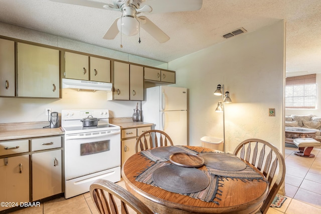 kitchen featuring a textured ceiling, ceiling fan, light tile patterned floors, and white appliances