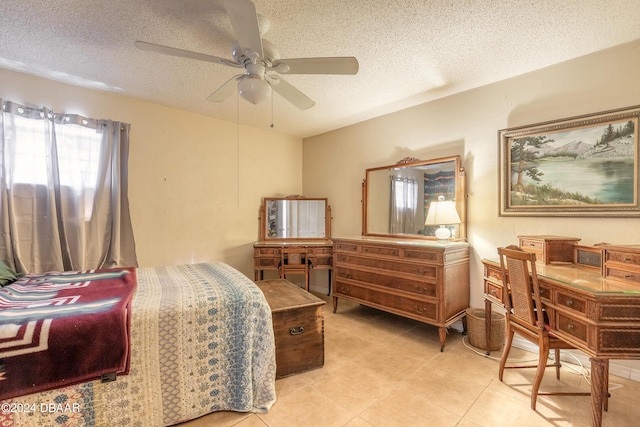 bedroom with ceiling fan and a textured ceiling