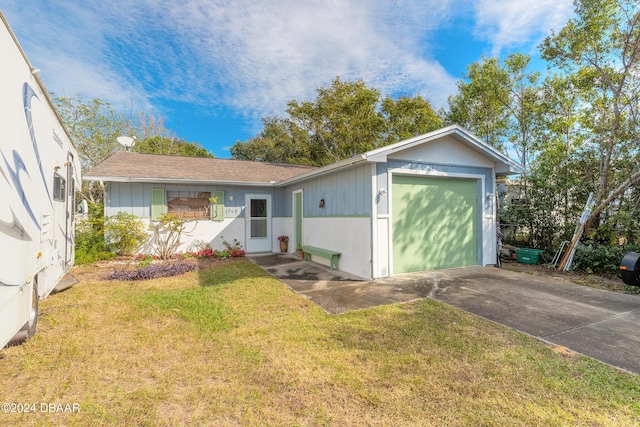 single story home featuring a garage and a front lawn