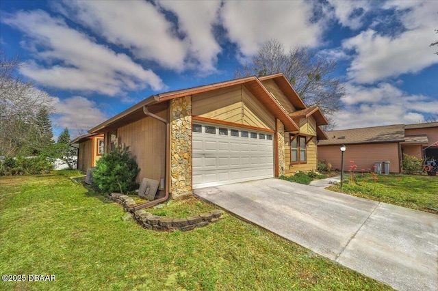 view of front of house with concrete driveway, an attached garage, cooling unit, stone siding, and a front lawn