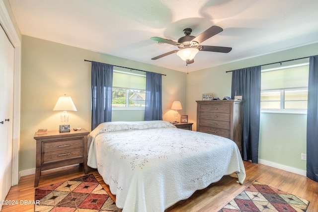 bedroom featuring hardwood / wood-style floors, ceiling fan, and a closet