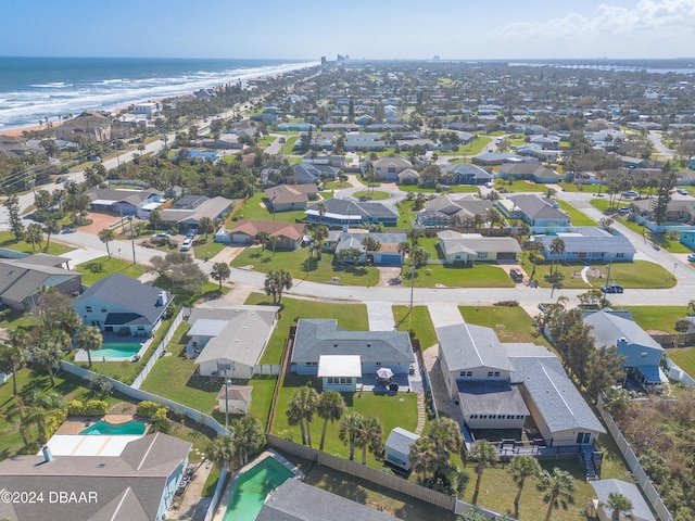 aerial view with a water view and a beach view