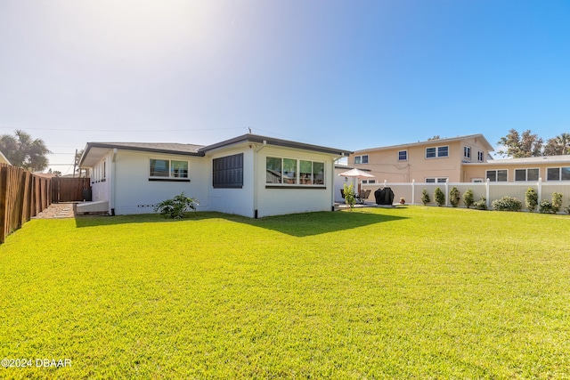 back of property featuring a lawn