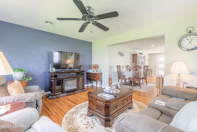 living room featuring hardwood / wood-style floors and ceiling fan