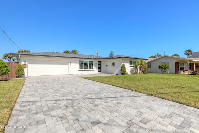 ranch-style home with a garage and a front lawn