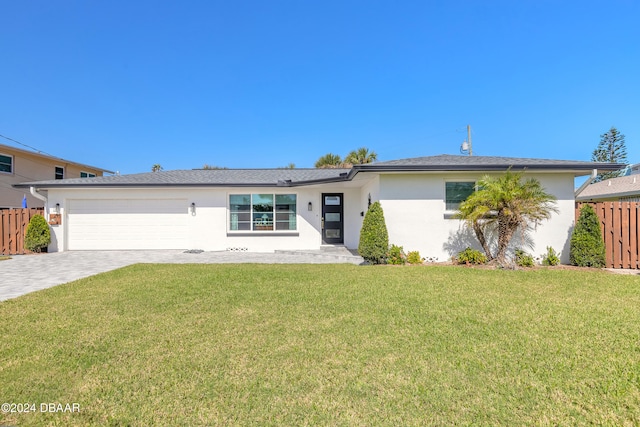 single story home featuring a garage and a front yard