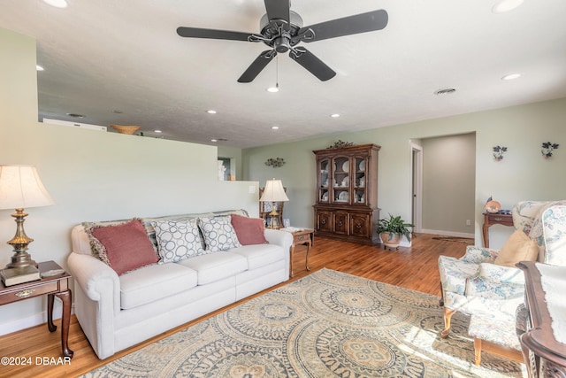 living room with light hardwood / wood-style floors and ceiling fan