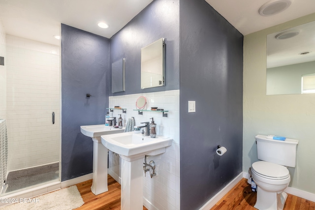 bathroom featuring toilet, a shower, backsplash, and wood-type flooring