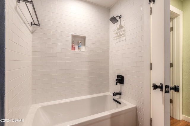 bathroom featuring hardwood / wood-style floors and tiled shower / bath combo